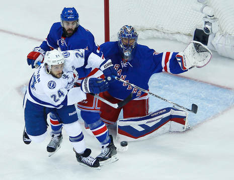 New York Rangers goalie Henrik Lundqvist (R) makes a save