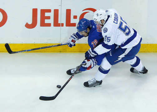 New York Rangers Chris Kreider (L) is checked by Tampa bay