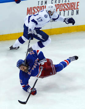 New York Rangers Dan Boyle (22) is knocked to the ice by