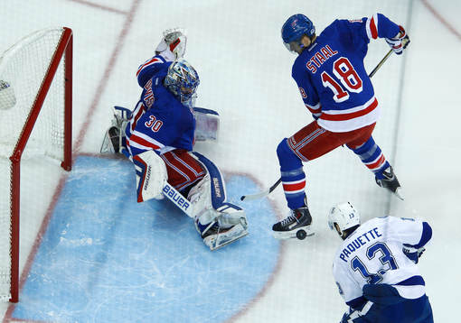 New York Rangers goalie Henrik Lundqvist (L) makes a save