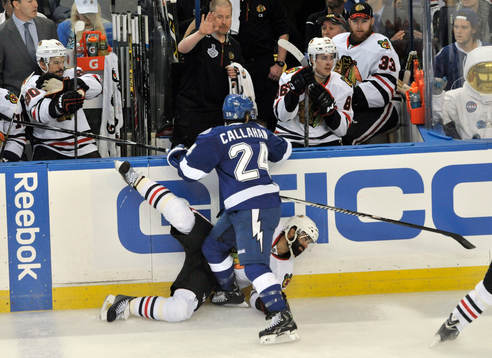 The Lightning's Ryan Callahan (24) checks the Blackhawks'