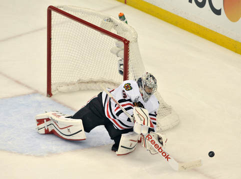 The Blackhawks goalie Corey Crawford (50) clears the puck
