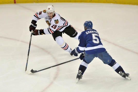 The Blackhawks' Jonathan Toews (19) moves the puck