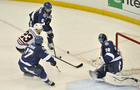 The Lightning's Ben Bishop (30) deflects a shot by the