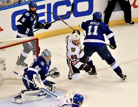 Blackhawks right wing Andrew Shaw falls as the Lightning's