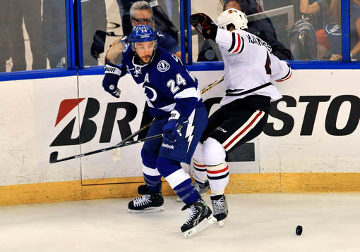 The Lightning's Ryan Calahan (24) checks Blackhawks