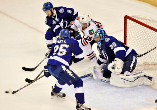 The Lightning's Matthew Carle (25) and Tyler Johnson (9)