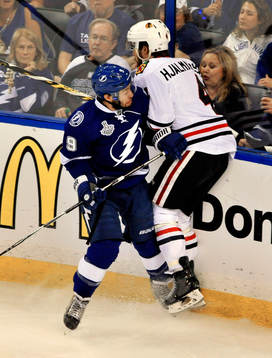 The Lightning's Tyler Johnson (9) checks Blackhawks