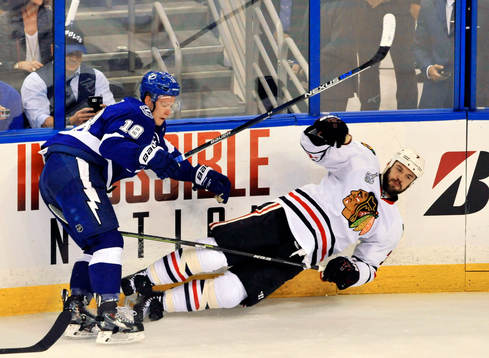 The Lightning's Ondrej Palat (18) checks the Blackhawks'