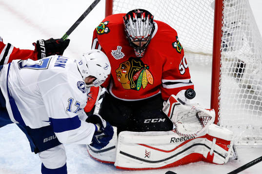 Chicago Blackhawks goalie Corey Crawford (50) deflects a