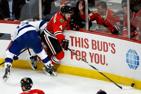 Chicago Blackhawks defenseman Niklas Hjalmarsson (4) slips