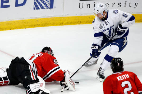 Chicago Blackhawks goalie Corey Crawford (50) deflects a