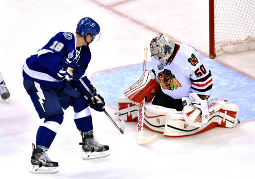 Chicago goalie Corey Crawford (50) stops a shot from Tampa