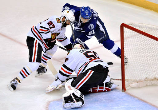 Chicago defenseman Johnny Oduya (27) helps goalie Corey