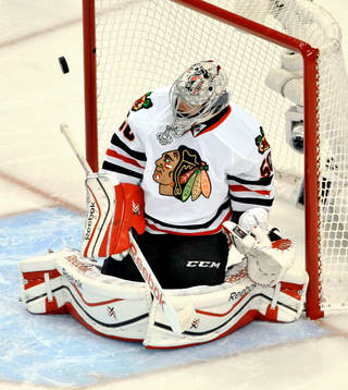 Chicago goalie Corey Crawford deflects a shot
