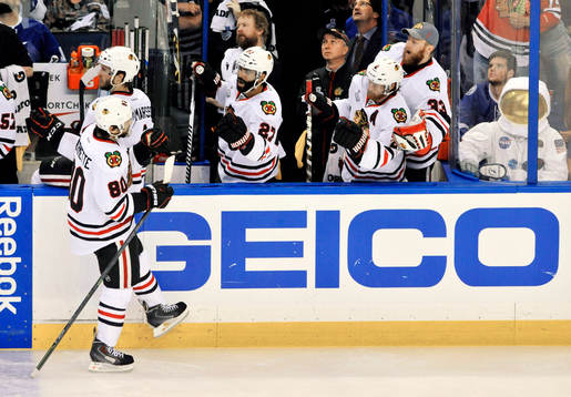 Chicago's Antoine Vermette (80) skate past Johnny Oduya