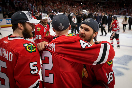 Chicago Blackhawks center Marcus Kruger (16) hugs left wing