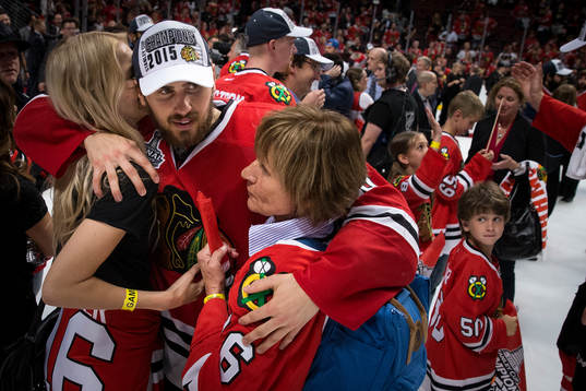 Chicago Blackhawks center Marcus Kruger (16) hugs friends