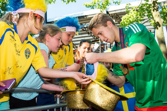 Sveriges målvakt Patrik Carlgren skriver autografer i