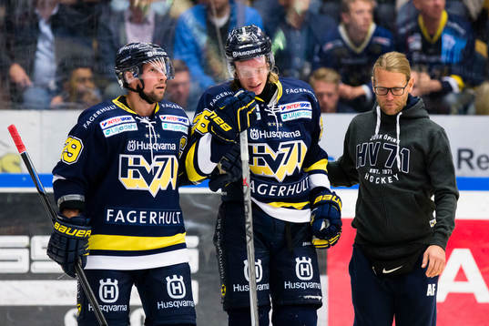 s Anton Bengtsson (i) leds av isen av HV71:s Chris Abbott