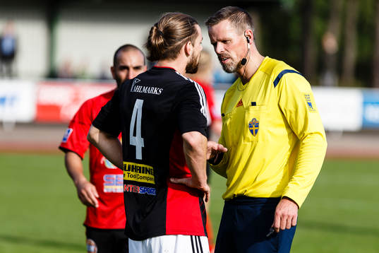 Domare Fredrik Olsson pratar med Lidköpings John Aikenhead