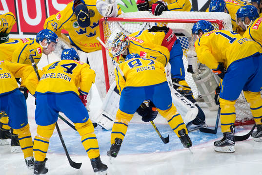 Sveriges spelare samlas runt målvakt Henrik Karlsson