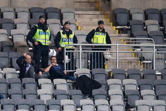 Tre poliser följer spelet från läktaren