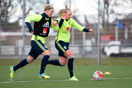 Sveriges Nilla Fischer i kamp om bollen med Stina