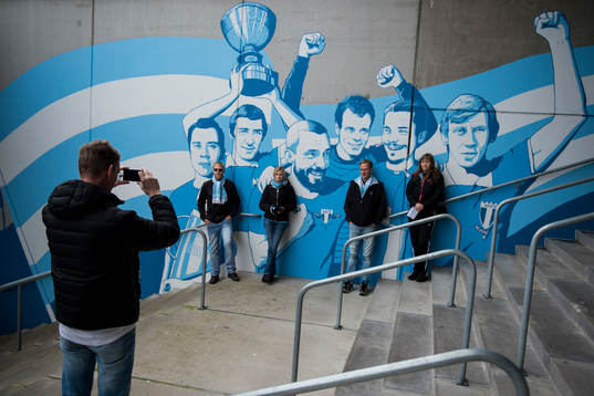 Malmö FF supportrar fotograferas framför en vägg med MFF