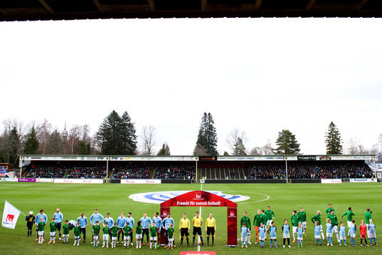 Lagen står uppställda vid lineup innan fotbollsmatchen i