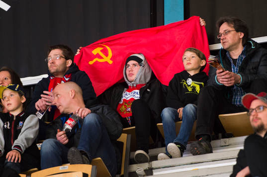 En rysk supporter sitter med Sovjets flagga