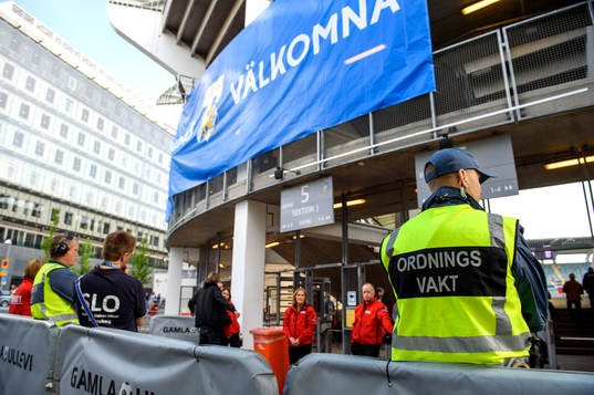 En ordningsvak utanför arenan innan fotbollsmatchen i