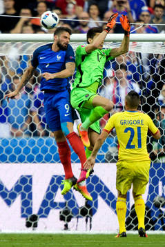 Frankrikes Olivier Giroud vinner en duell mot Rumäniens