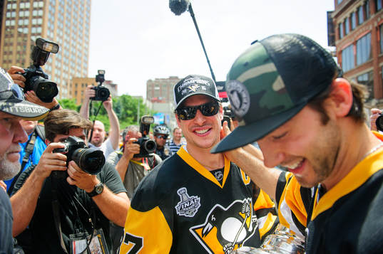 Pittsburgh Penguins Chris Letang (58, left) hands the