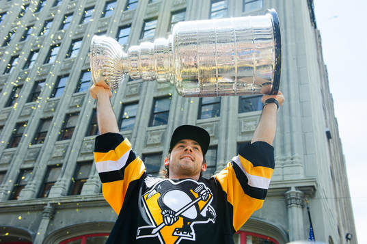 Pittsburgh Penguins Chris Letang (58) lifts the Stanley Cup