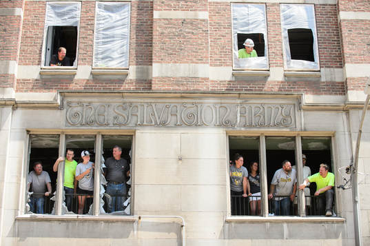 Local construction workers try to get a view of the scene