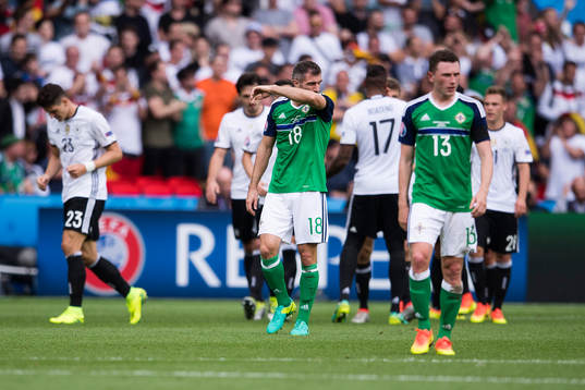 Nordirlands Aaron Hughes deppar i fotbollsmatchen mellan