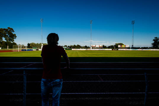 Supporter står och tittar ut över planen på Ängelholms