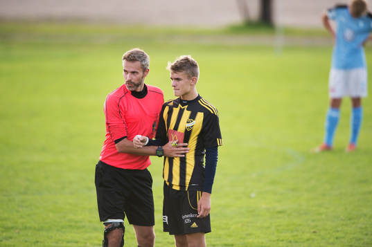 Domaren och  IFK Hässleholms Elliot Nilsson i matchen för
