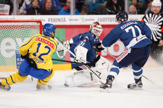 Sweden¥s Fredrik Pettersson, Finland's goalie Juha Metsola