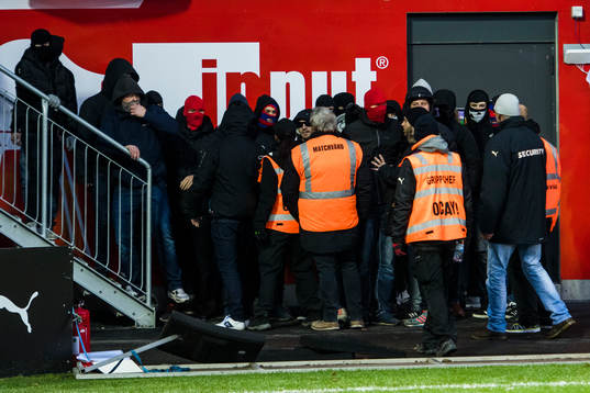 Funktionärer försöker stoppa supportrar som tagit sig