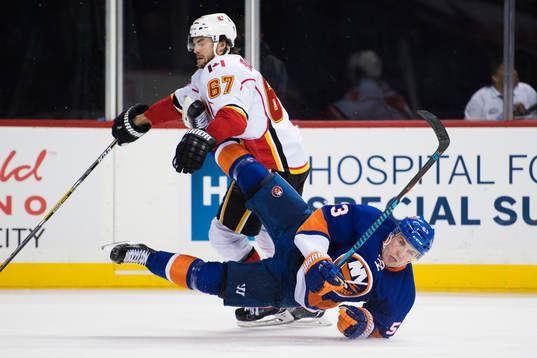 Calgarys Michael Frolik tacklar New Yorks Casey Cizikas