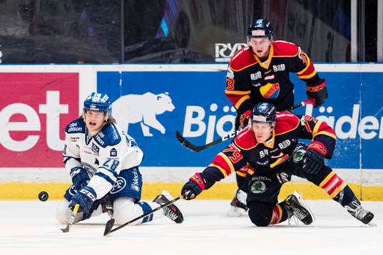 Leksands William Wikman i kamp om pucken med Djurgårdens