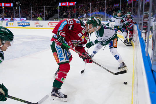 Frölundas Simon Hjalmarsson i kamp om pucken vid sargen