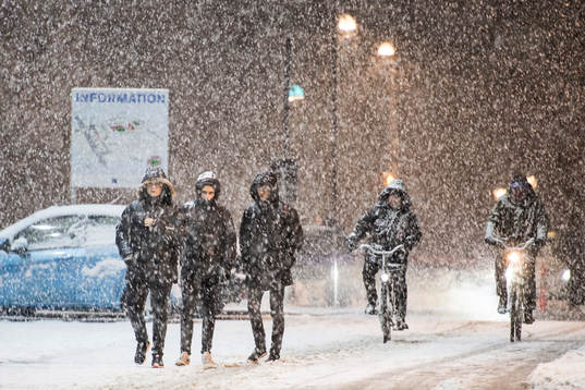 Människor ute på promenad utanför arenan i tungt