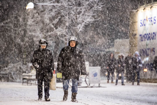 Människor ute på promenad utanför arenan i tungt