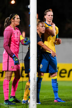 Sveriges Lotta Schelin  grinar illa och tar sig mot axeln
