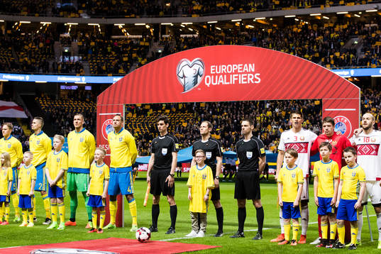 Sveriges och Belarus spelare samt domare ställer upp sig