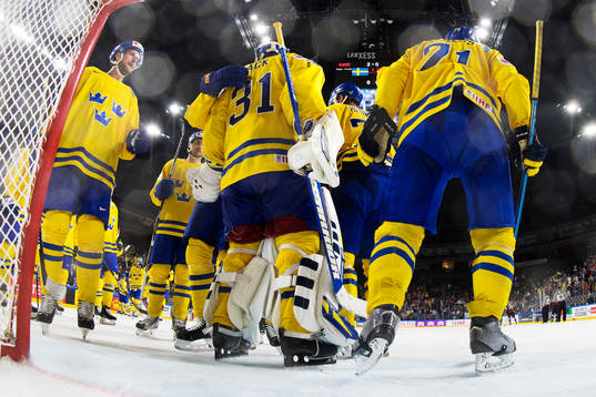 Sveriges målvakt Eddie Läck kramas om av medspelare