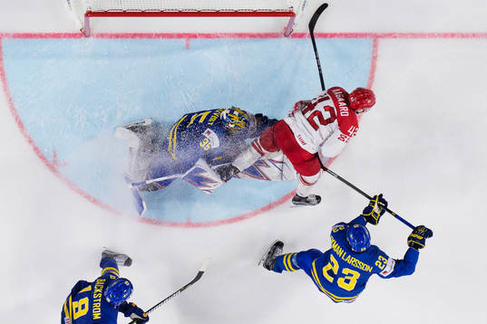 Sveriges målvakt Henrik Lundqvist blir pååkt av Danmarks